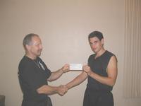 Sifu Hardy presenting Goanna (Pierre Skorich) with a cheque for $500, to help him on his way the the US Shaolin White Dragon Camp, with Grandmaster St Charles.