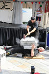 Sifu Bellchambers starts to smash his way with a sledgehammer through about 180kg of concrete on Master Hardy's Chest, while he lies on a bed of nails