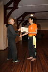 Grand Master Hardy presents Howell with his Yellow Sash certificate.