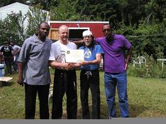 Master Hardy is presented with his Masters Certificate by Pai Shinzan, with Master Harris (left) and Master Sanders (right)